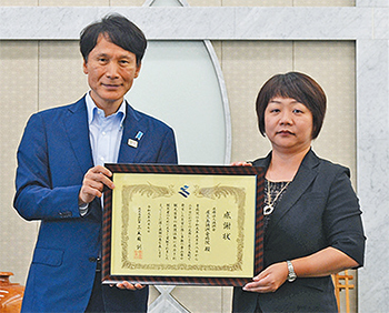三反園知事（左）から泊・総看護師長に感謝状を贈呈